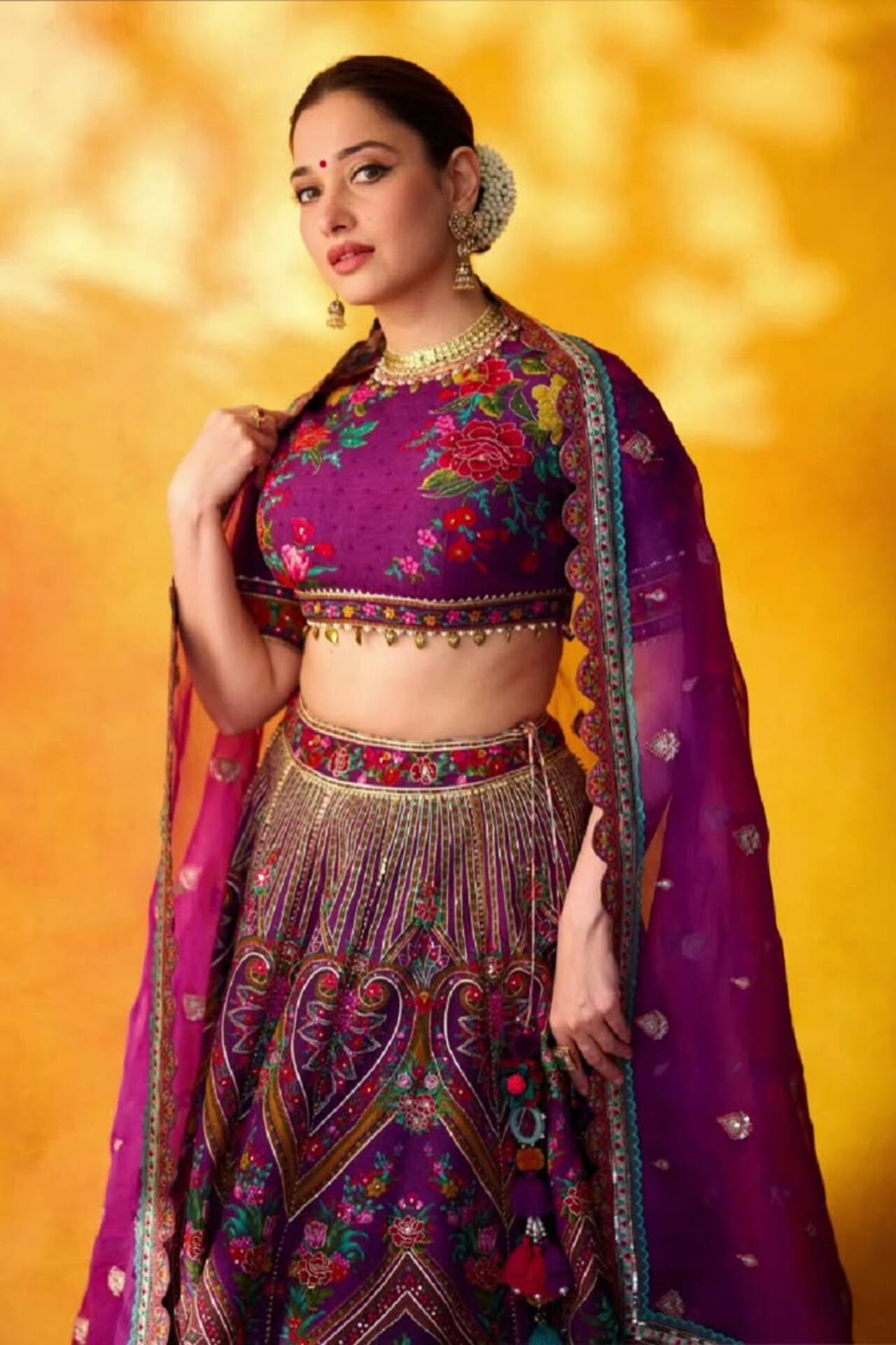 Wanna go full desi? Go with Tamannaah Bhatia's purple lehenga choli with colourful design for festive vibes.